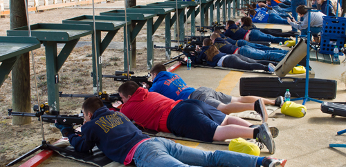 air rifle match competitor prone shooting from left